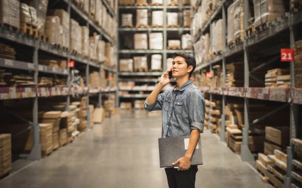 manager on phone in warehouse