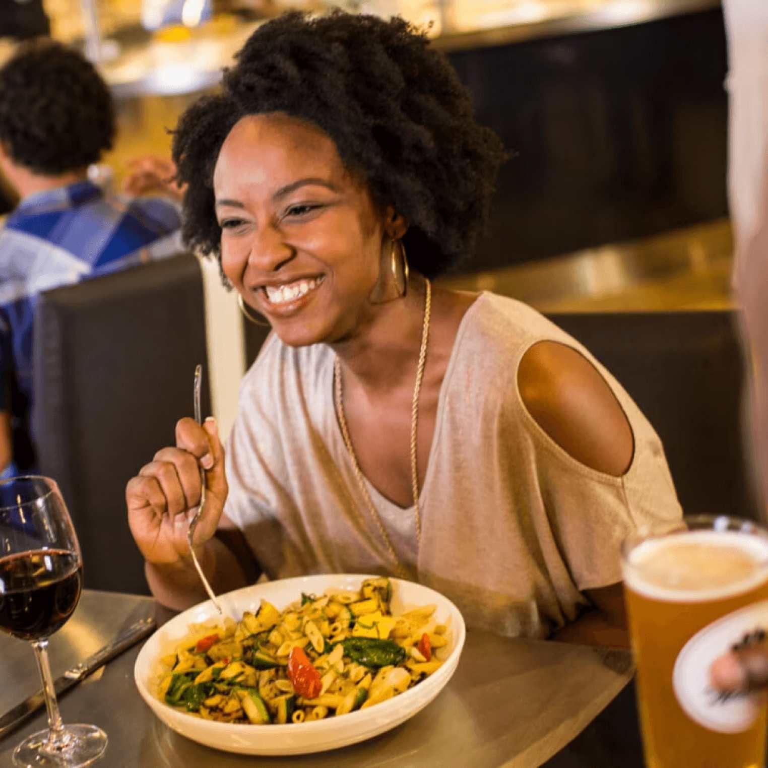 woman smiling eating food